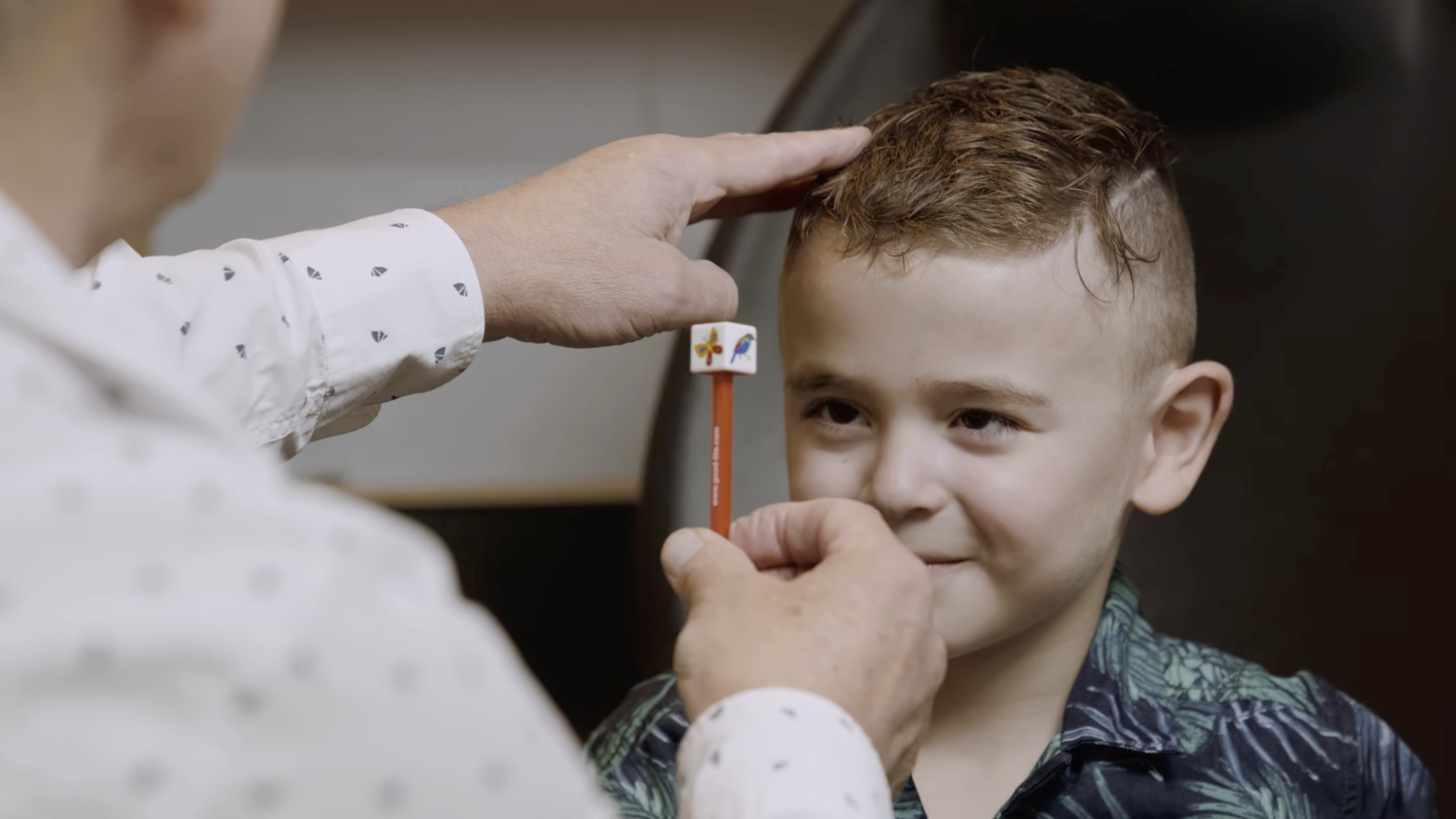 Boy with eye tool infront of him in the middle of a eye test